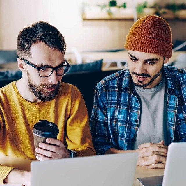 Two people at coffee shop working on Canvas Studio